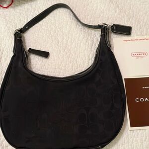 Authentic Coach small Black Hobo bag with zip closure & leather bottom.
